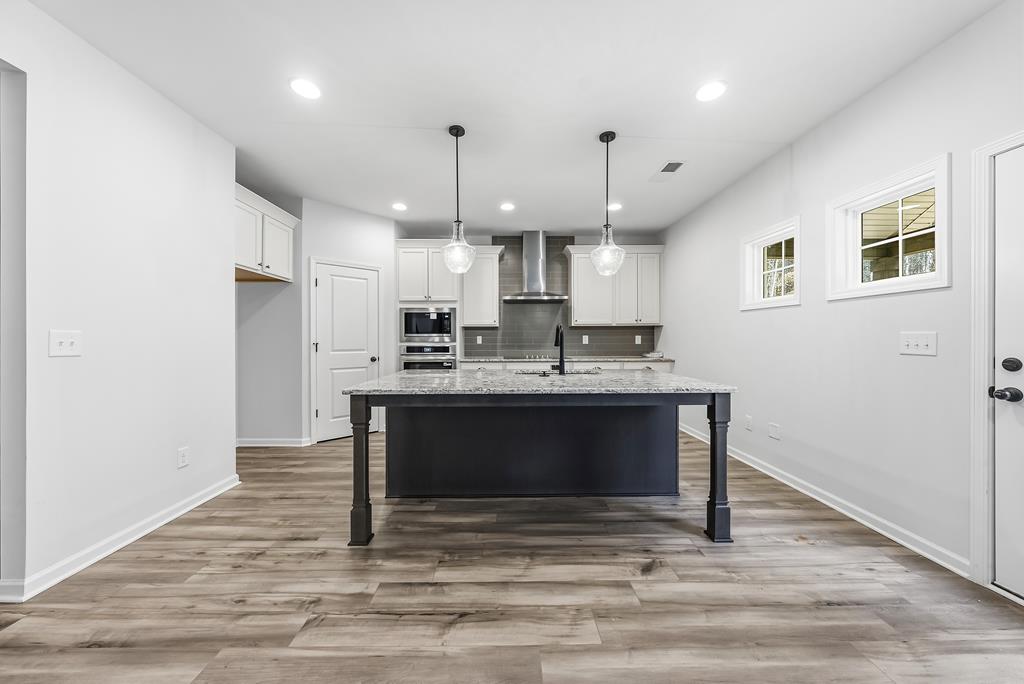 75 Oak Ridge Drive Waverly Hall, GA 31831 - Photo 14 of 40 a kitchen with kitchen island a sink stainless steel appliances and cabinets