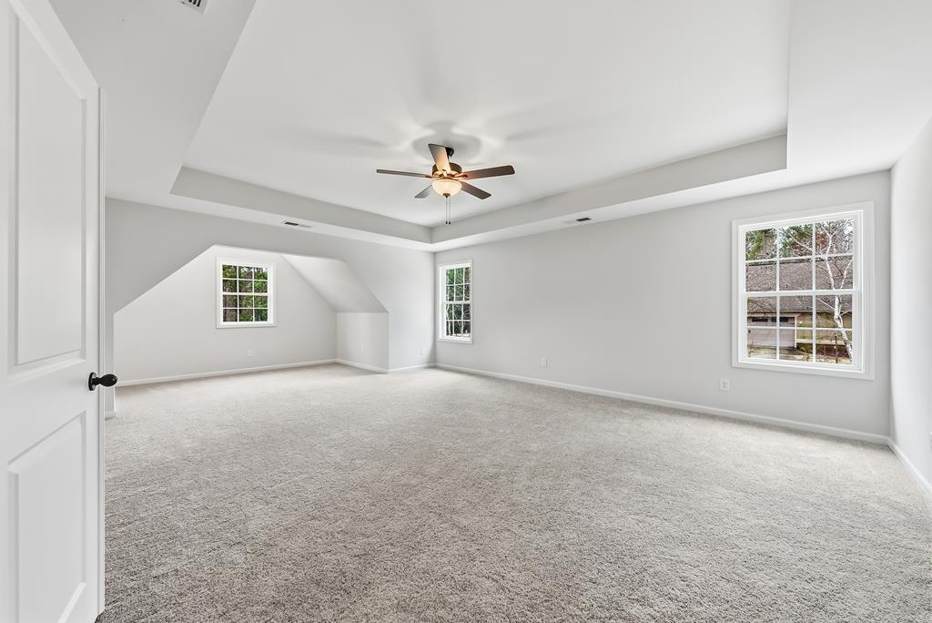75 Oak Ridge Drive Waverly Hall, GA 31831 - Photo 22 of 40 an empty room with windows and ceiling fan