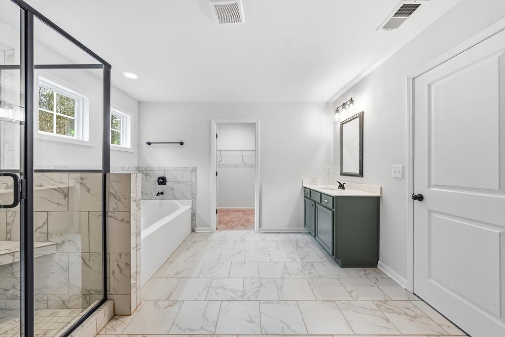 75 Oak Ridge Drive Waverly Hall, GA 31831 - Photo 24 of 40 a bathroom with a tub shower and mirror