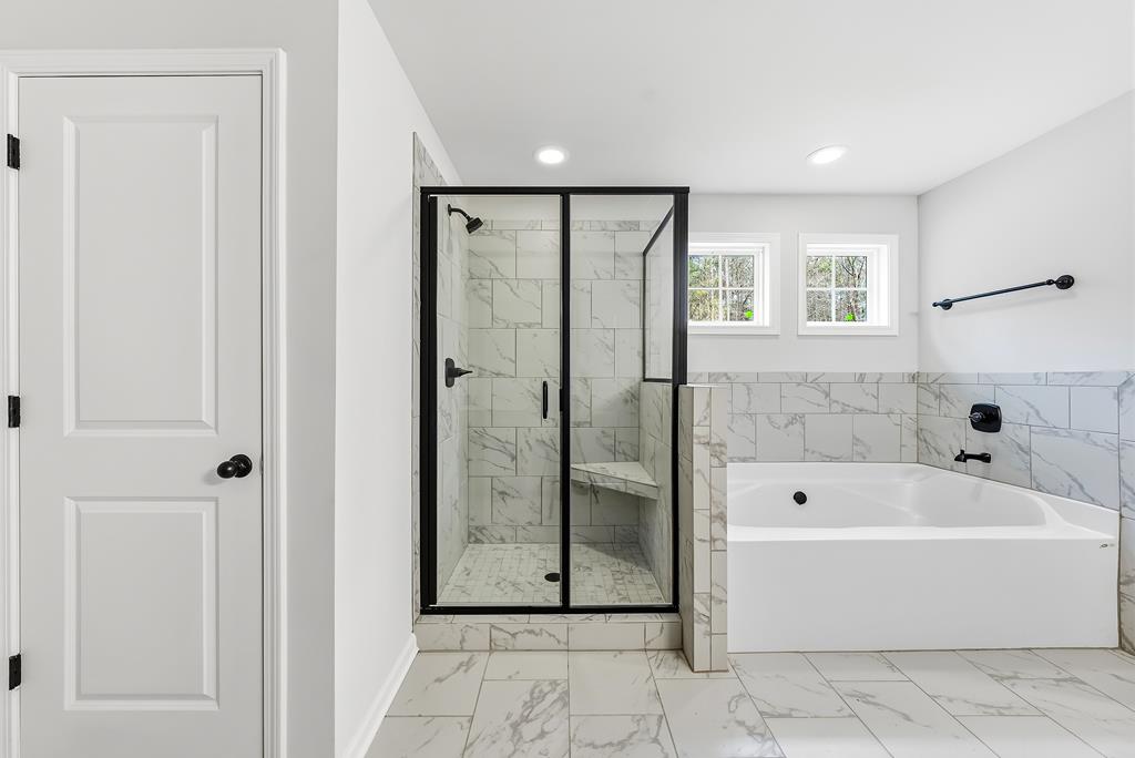 75 Oak Ridge Drive Waverly Hall, GA 31831 - Photo 26 of 40 a bathroom with a bathtub and a shower