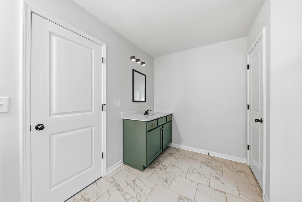 75 Oak Ridge Drive Waverly Hall, GA 31831 - Photo 27 of 40 a room that has a sink and a mirror