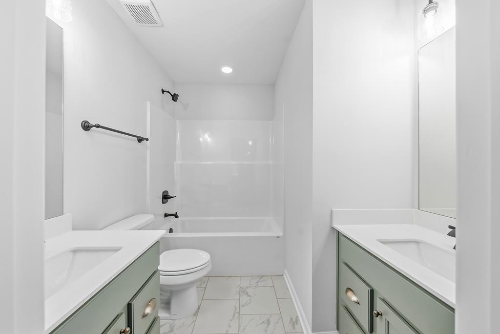 75 Oak Ridge Drive Waverly Hall, GA 31831 - Photo 34 of 40 a bathroom with a granite countertop sink a toilet and shower