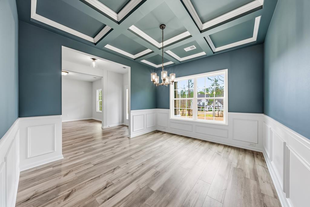 75 Oak Ridge Drive Waverly Hall, GA 31831 - Photo 9 of 40 a view of an empty room with wooden floor and a window