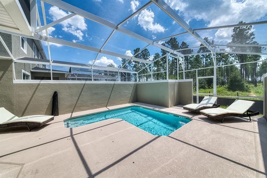 400 Ocean Course Avenue Davenport, FL 33896 - Photo 18 of 34 a view of a swimming pool with a patio