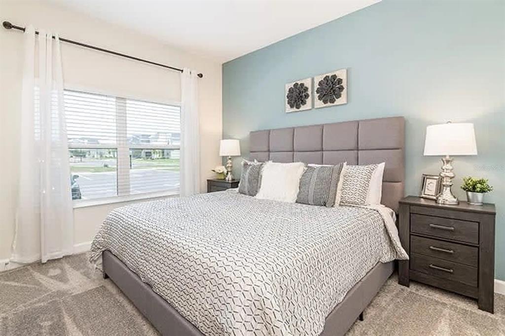 400 Ocean Course Avenue Davenport, FL 33896 - Photo 7 of 34 a bedroom with a bed and a window