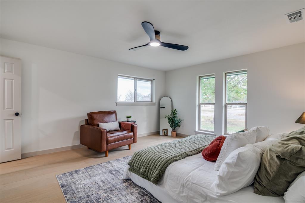 5109 Old Gate Lane Parker, TX 75002 - Photo 12 of 24 a bedroom with a balcony a bed and a large window