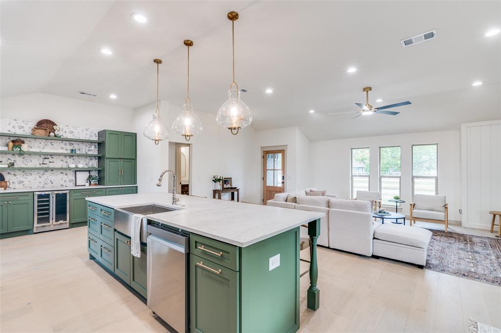 5109 Old Gate Lane Parker, TX 75002 - Photo 5 of 24 a open kitchen with stainless steel appliances granite countertop a sink a stove and a wooden floors