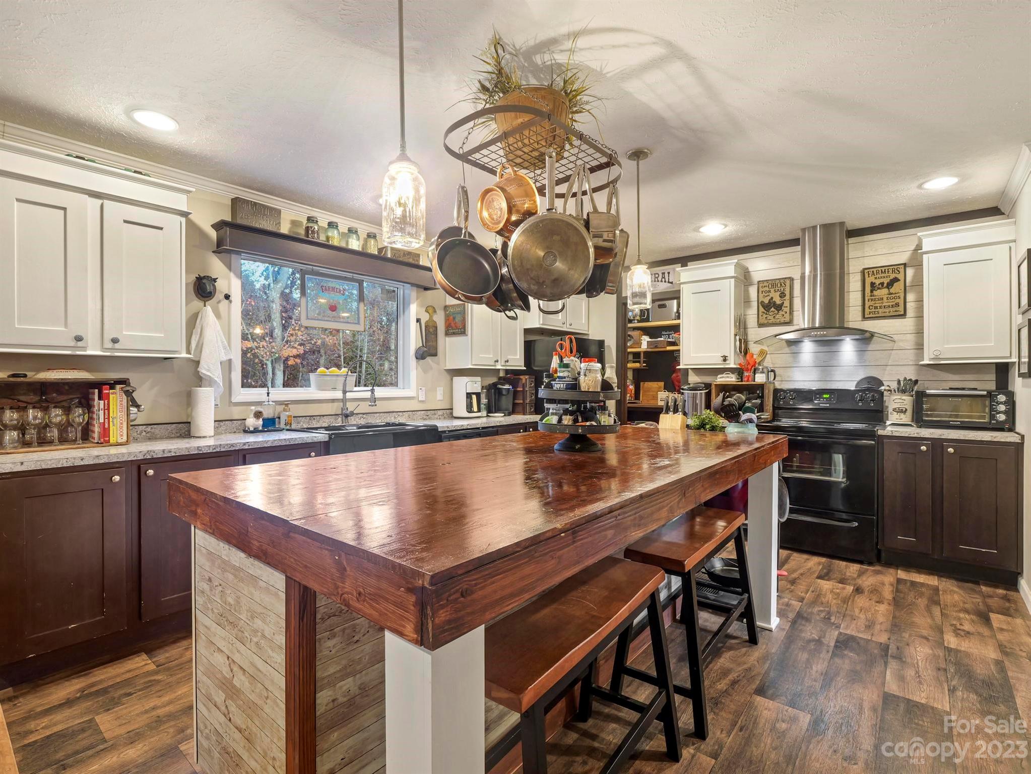 139 Phils Circle Rutherfordton, NC 28139 - Photo 15 of 37 a kitchen with stainless steel appliances granite countertop a sink a stove and a wooden floors