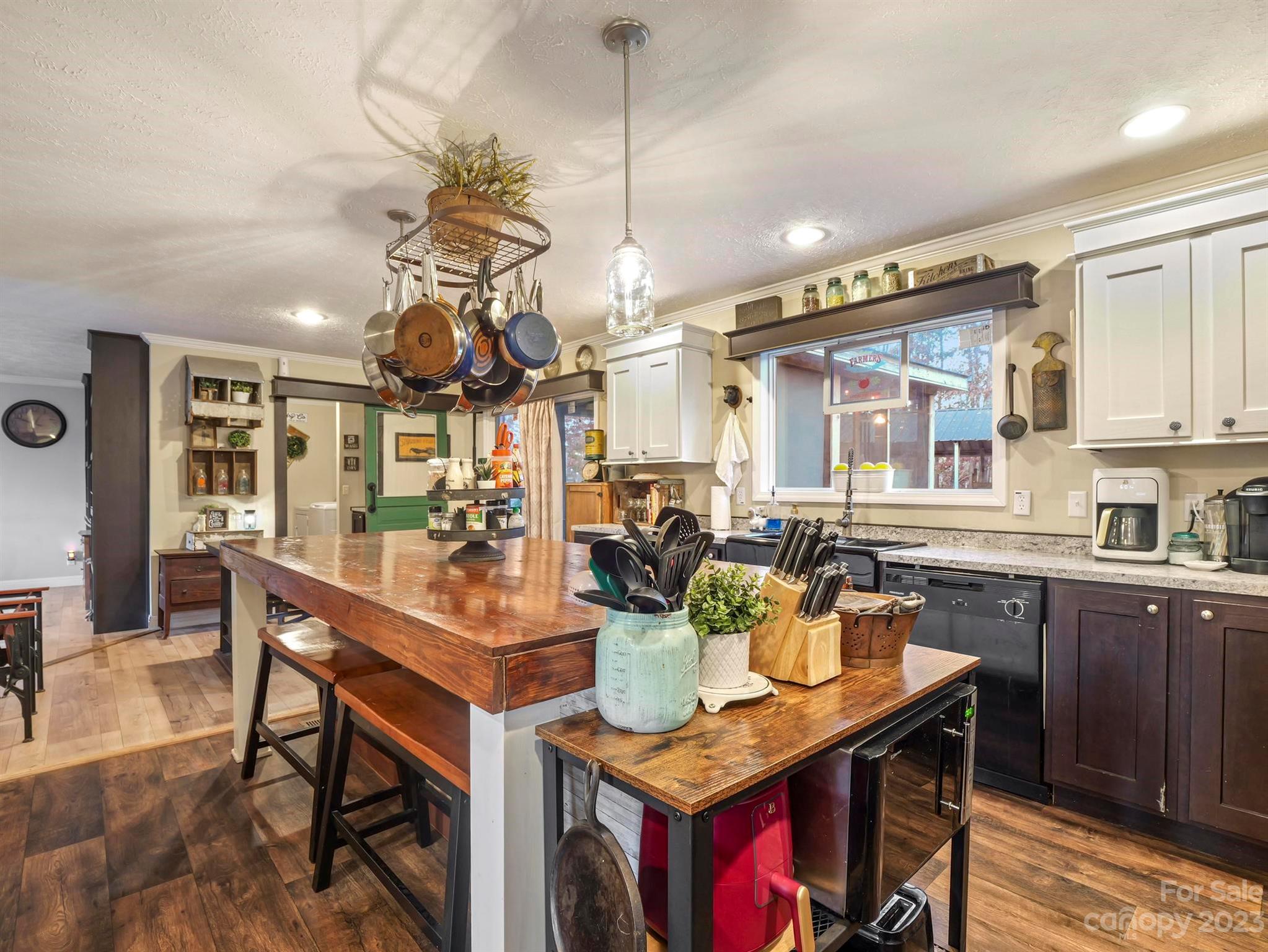 139 Phils Circle Rutherfordton, NC 28139 - Photo 17 of 37 a view of a dining room and livingroom with furniture wooden floor a rug a painting and a chandelier