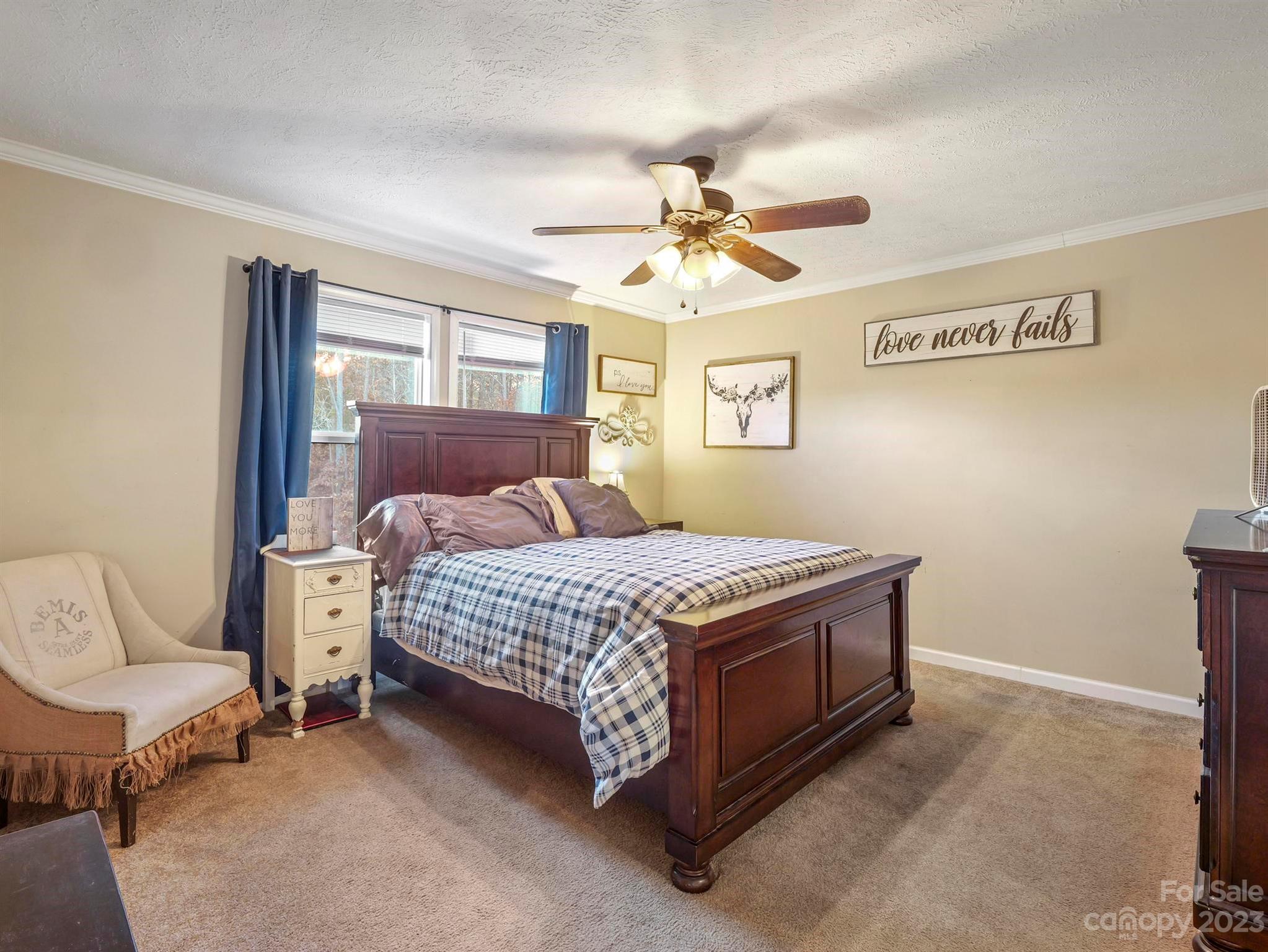 139 Phils Circle Rutherfordton, NC 28139 - Photo 19 of 37 a bedroom with a bed and a chandelier