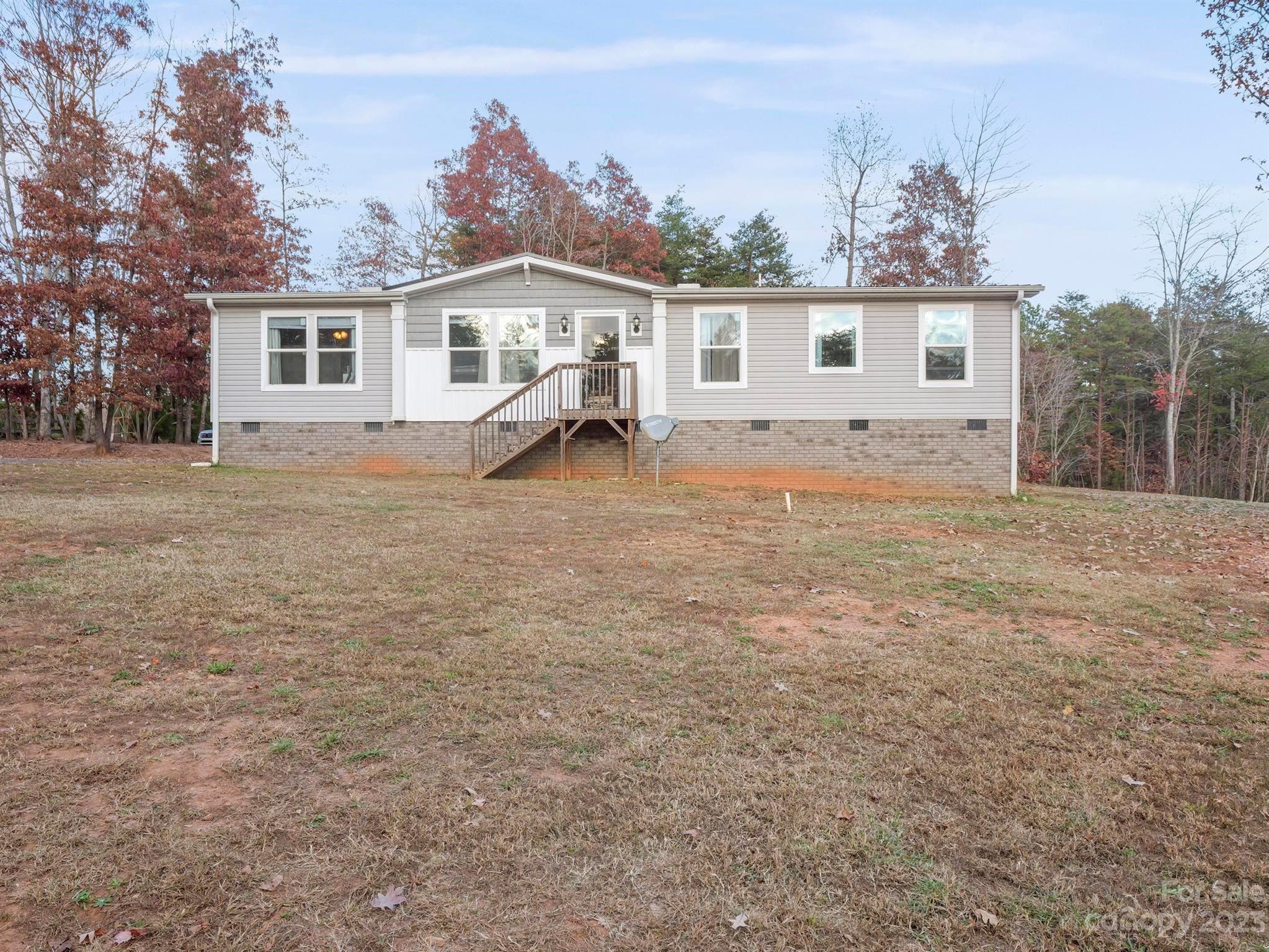 139 Phils Circle Rutherfordton, NC 28139 - Photo 2 of 37 a view of a yard with a house and a tree