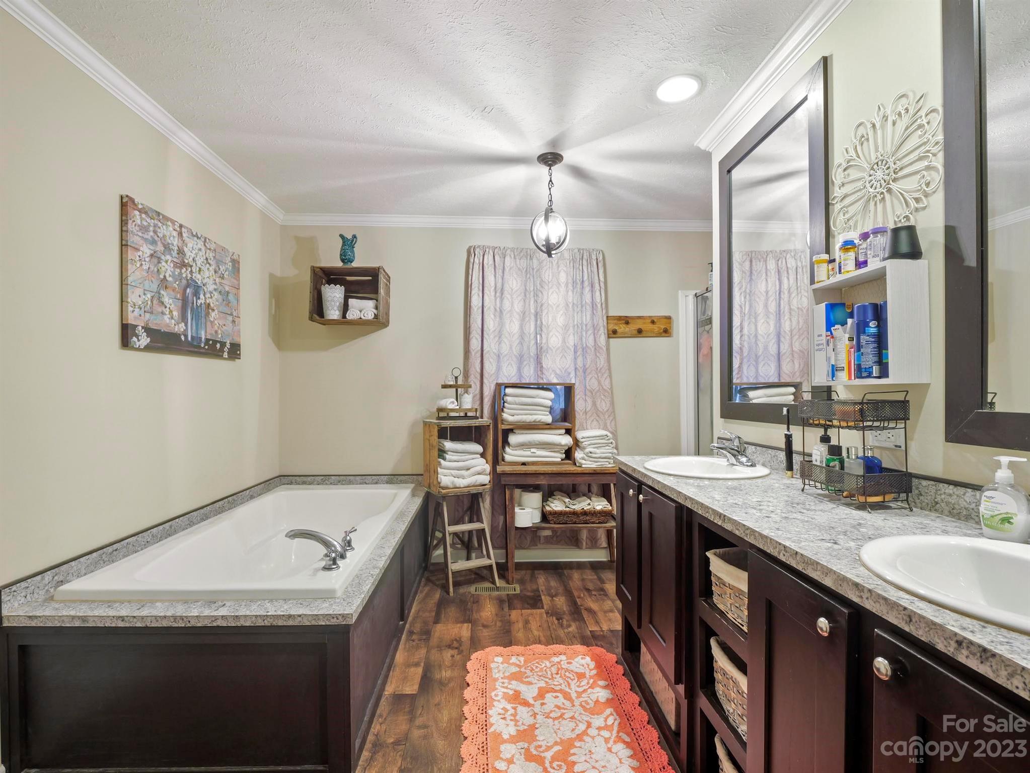 139 Phils Circle Rutherfordton, NC 28139 - Photo 21 of 37 a bathroom with a granite countertop sink a mirror a vanity and a bathtub