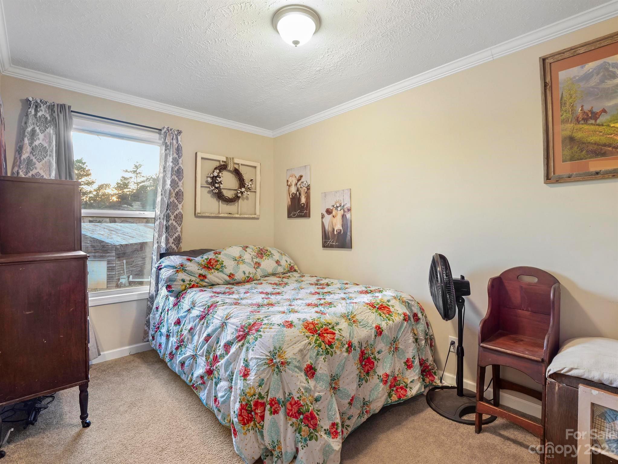139 Phils Circle Rutherfordton, NC 28139 - Photo 25 of 37 a bedroom with a bed a baby desk and chair next to a window