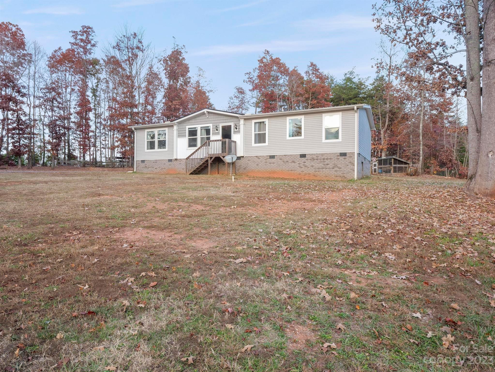 139 Phils Circle Rutherfordton, NC 28139 - Photo 3 of 37 a front view of a house with a garden and trees