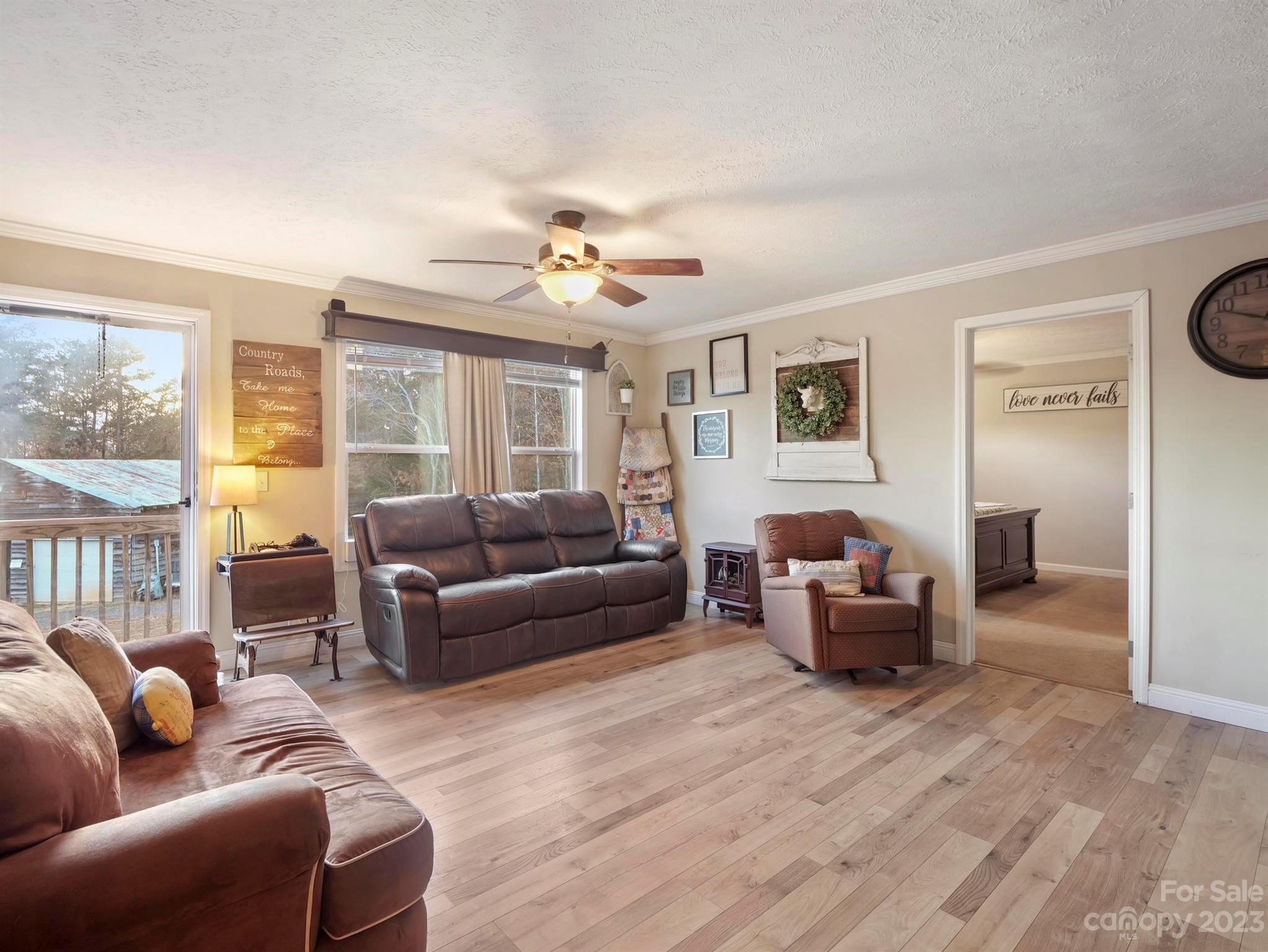 139 Phils Circle Rutherfordton, NC 28139 - Photo 10 of 37 a living room with furniture a ceiling fan and a window