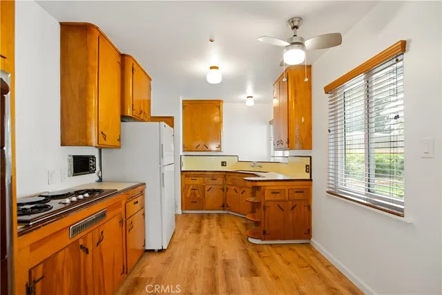 a kitchen with stainless steel appliances granite countertop a stove a sink dishwasher and a refrigerator