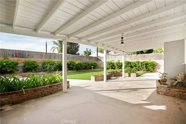 a view of a porch and garden in the back
