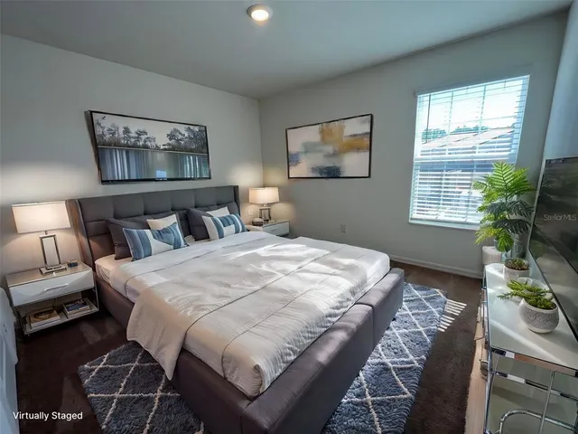 a bedroom with bed and a potted plant