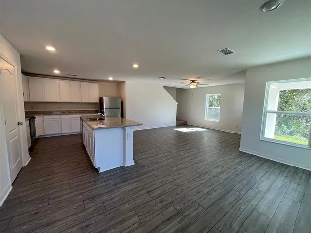 a view of kitchen with wooden floor and electronic appliances