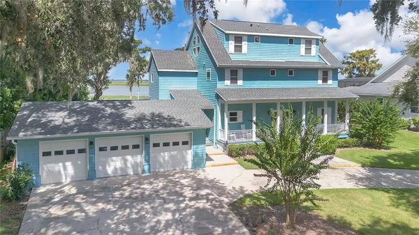 a front view of a house with a garden and plants