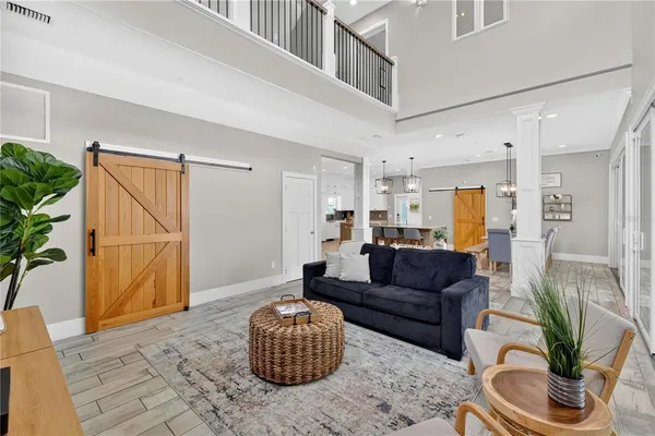 a living room with furniture and a floor to ceiling window