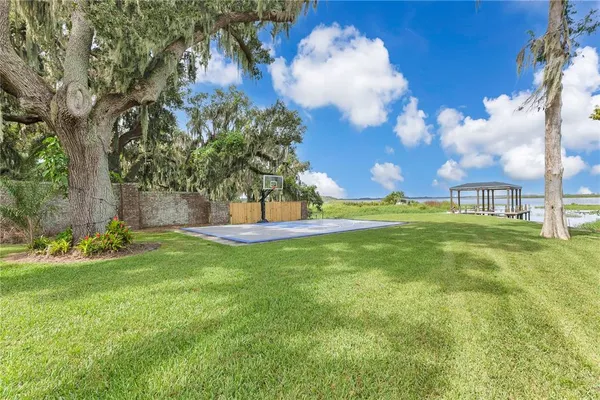 a backyard of a house with wooden floor and outdoor seating