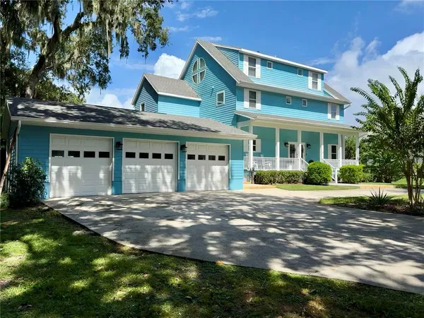 an aerial view of a house with a yard and swimming pool