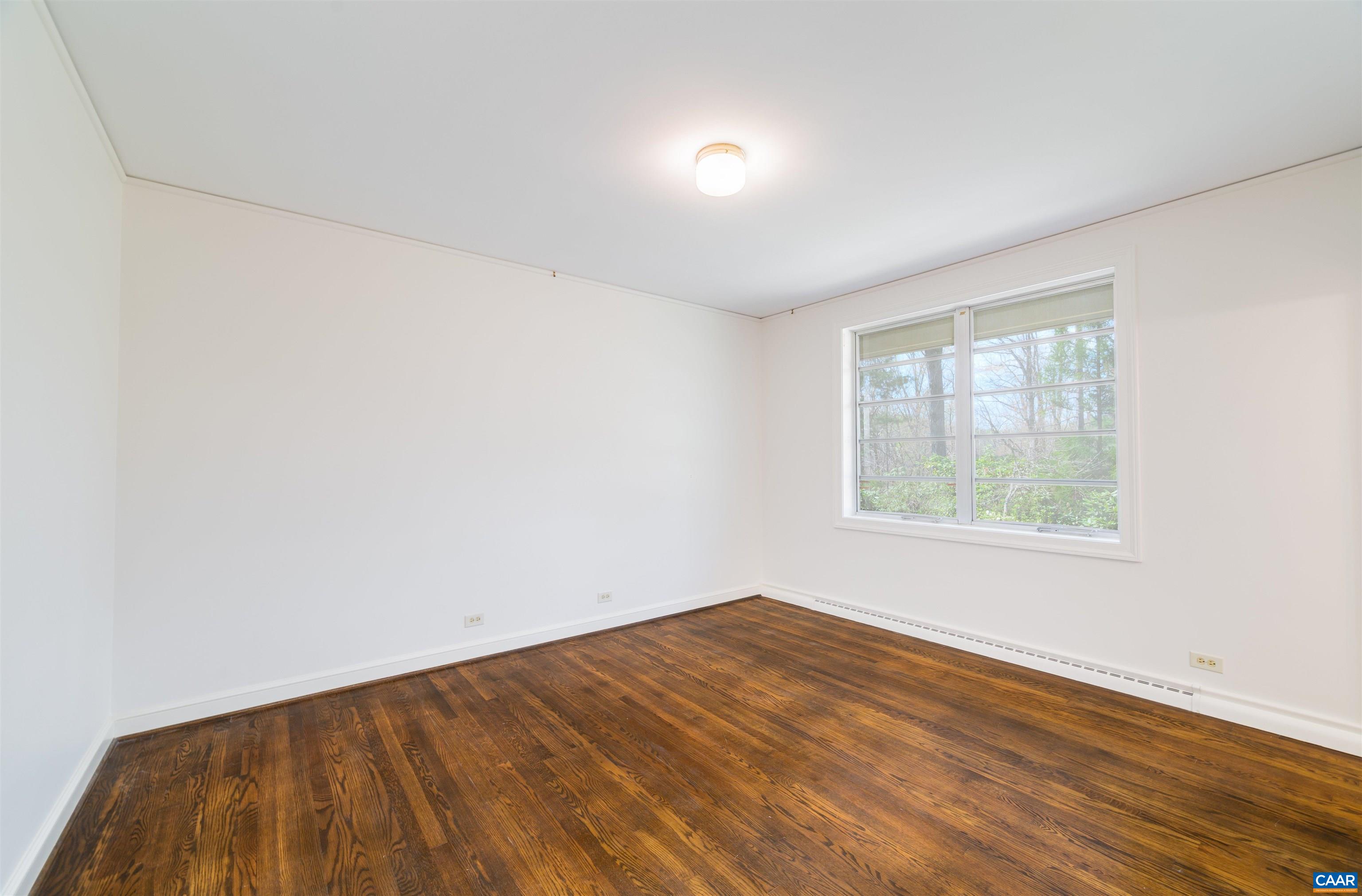 275 Terrell Road West Charlottesville, VA 22901 - Photo 39 of 68 an empty room with wooden floor and windows