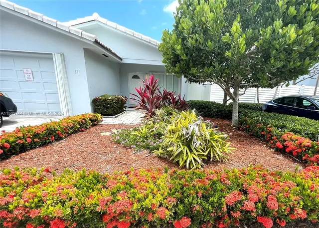 a view of a backyard with potted plants