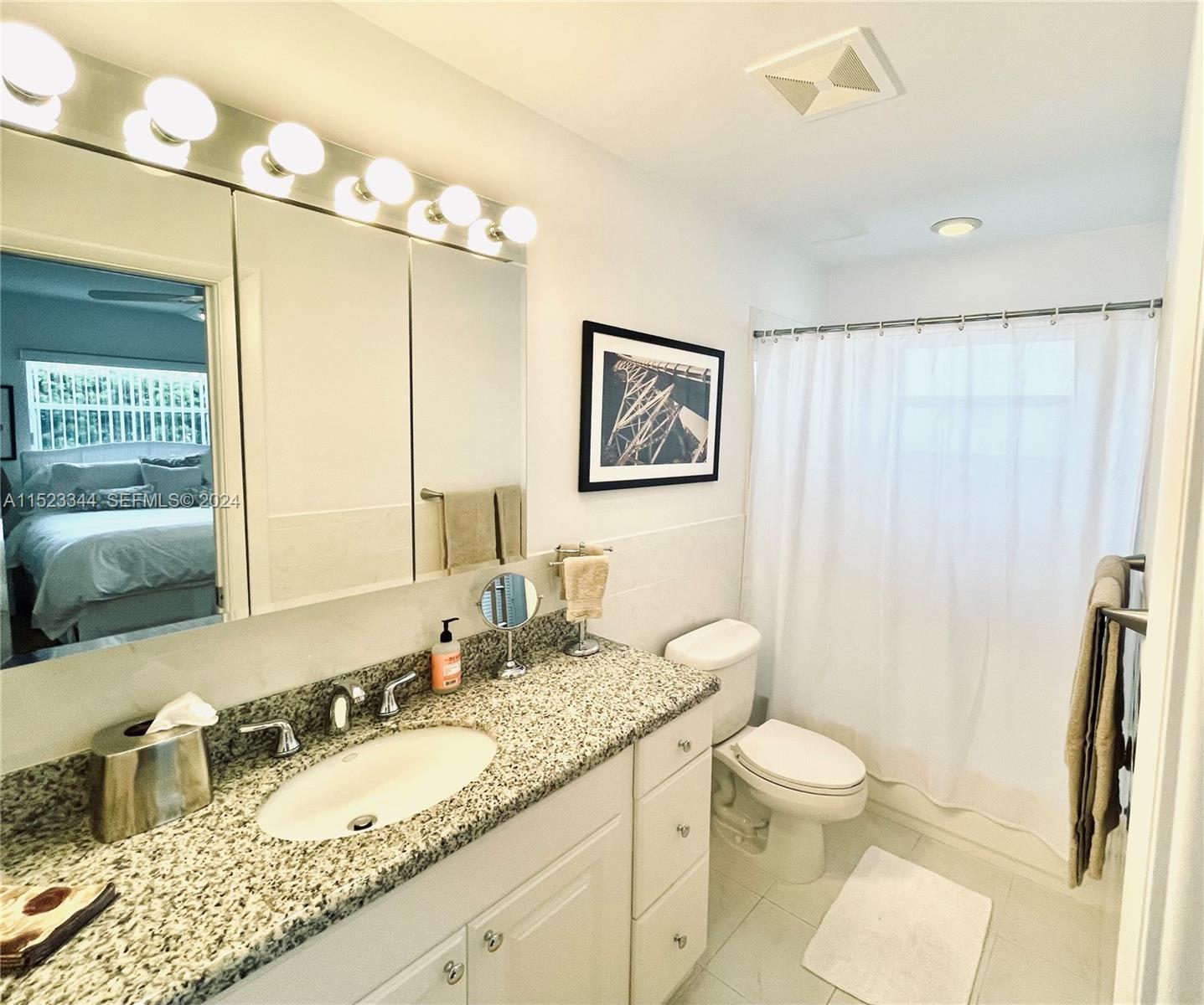 331 Desoto Street Hollywood, FL 33019 - Photo 12 of 12 a bathroom with a granite countertop sink mirror vanity and toilet