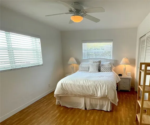 a bedroom with a bed and painting on the wall