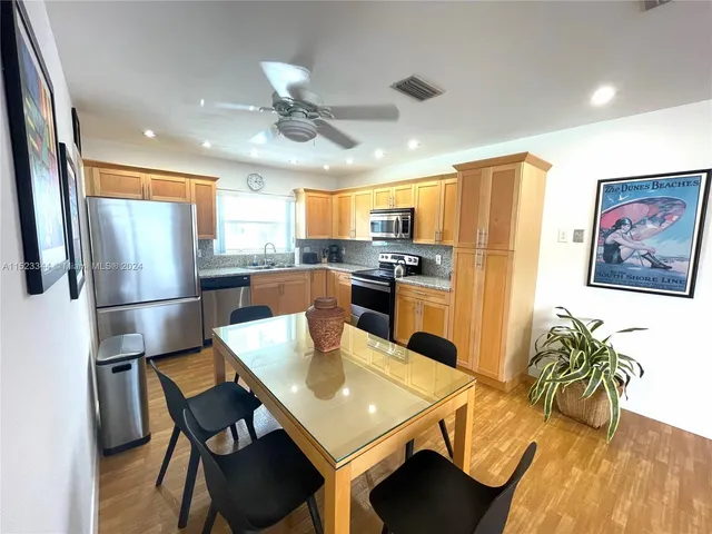 a dining room with furniture and wooden floor