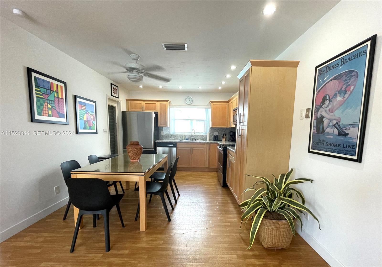 331 Desoto Street Hollywood, FL 33019 - Photo 10 of 12 a dining room with furniture and wooden floor