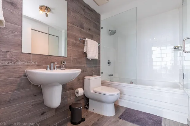 a bathroom with a sink toilet and shower