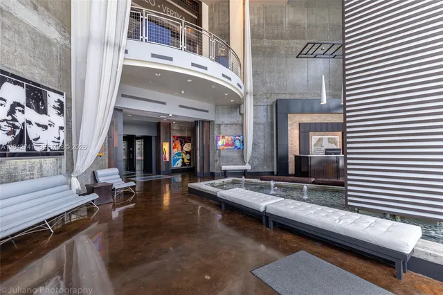 a living room with furniture and a floor to ceiling window