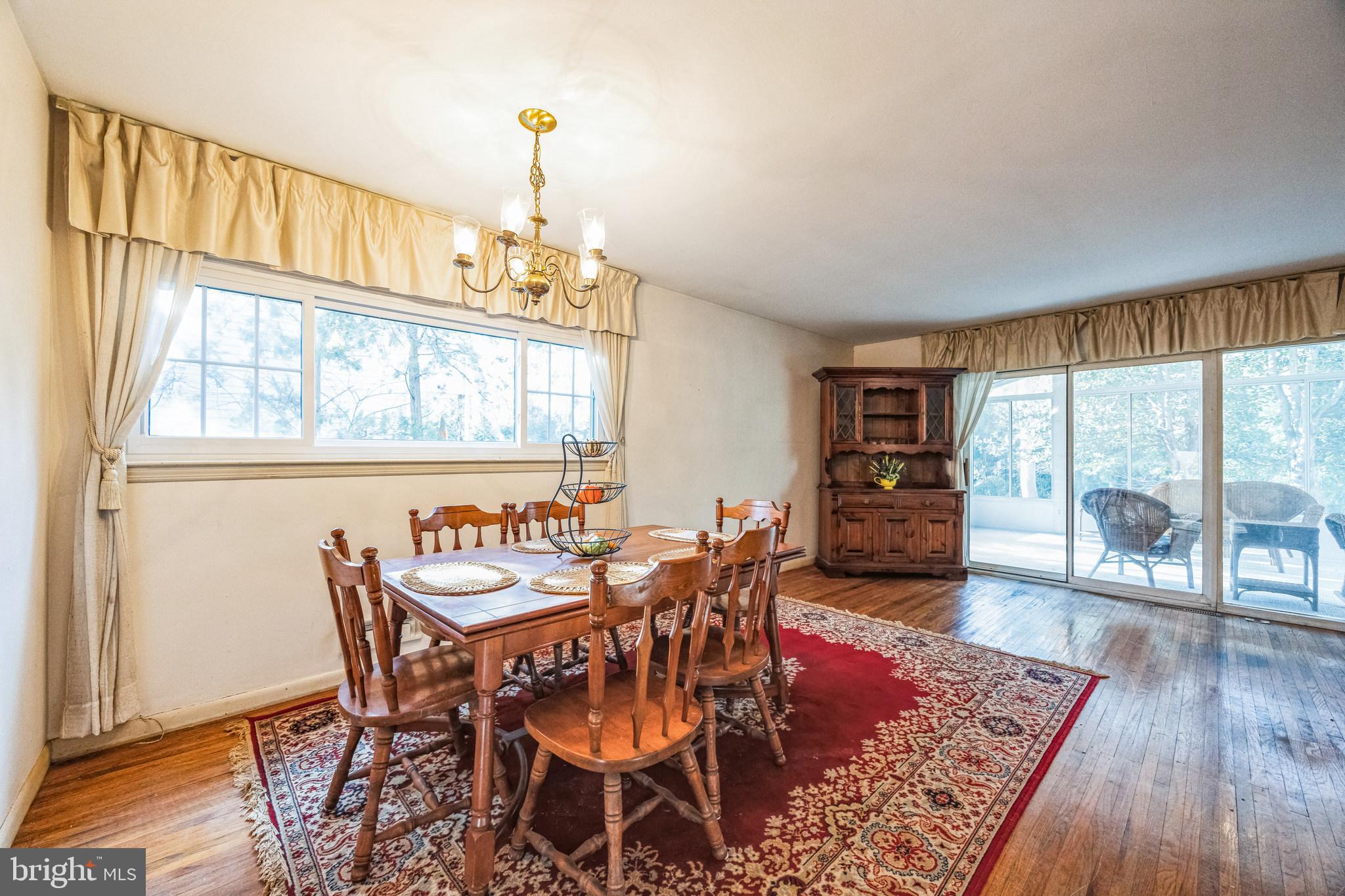 1246 Forge Road Cherry Hill, NJ 08034 - Photo 13 of 34 a dining room with furniture a chandelier and wooden floor