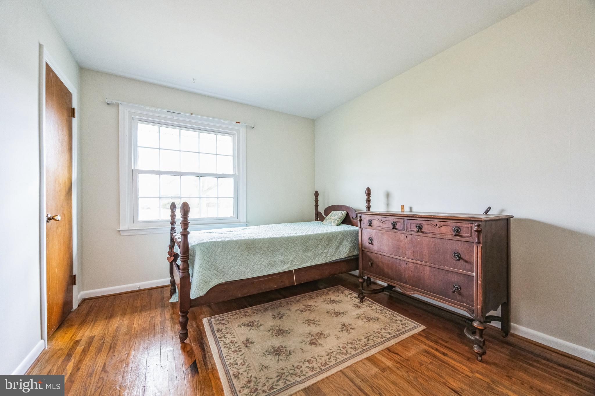 1246 Forge Road Cherry Hill, NJ 08034 - Photo 28 of 34 a bedroom with a bed and wooden floor