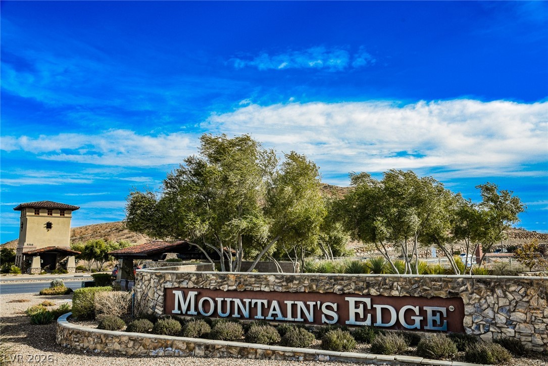 9916 Sable Point Street Las Vegas, NV 89178 - Photo 68 of 73 Enter a community featuring desert landscaping and mountain views, offering serene living.