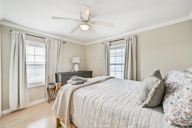 a bedroom with a large bed and a window