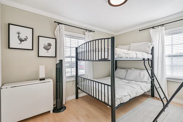 a view of a bedroom with baby bed and a window