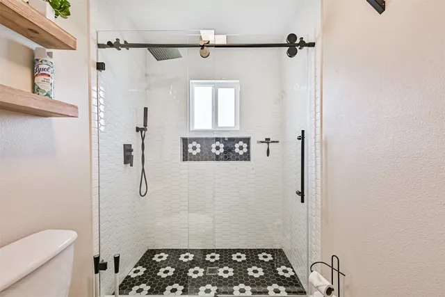 a bathroom with a shower toilet and sink
