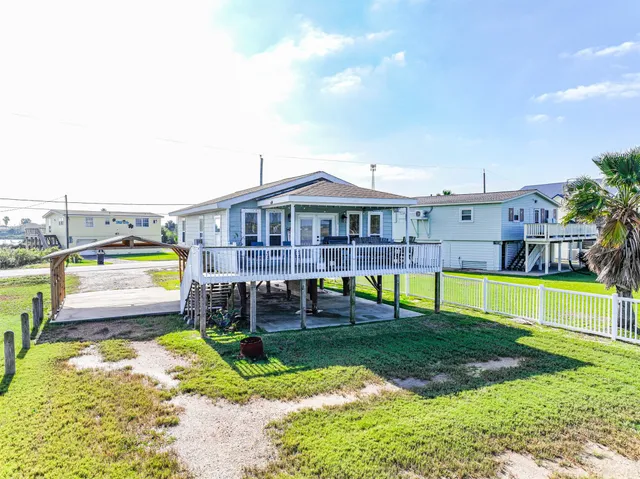 a view of a swimming pool with a yard and plants