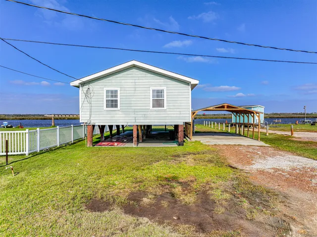 a view of a house with a yard and sitting area