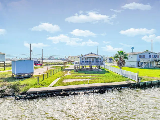 a swimming pool with outdoor seating and yard in back
