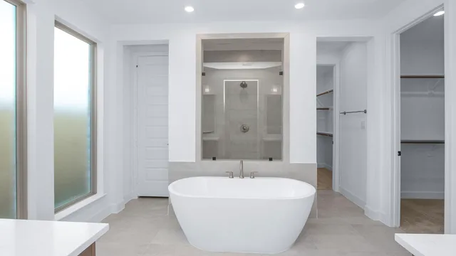 a white bath tub sitting in a en suite bathroom