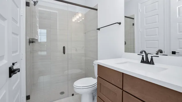 a bathroom with a sink toilet and shower