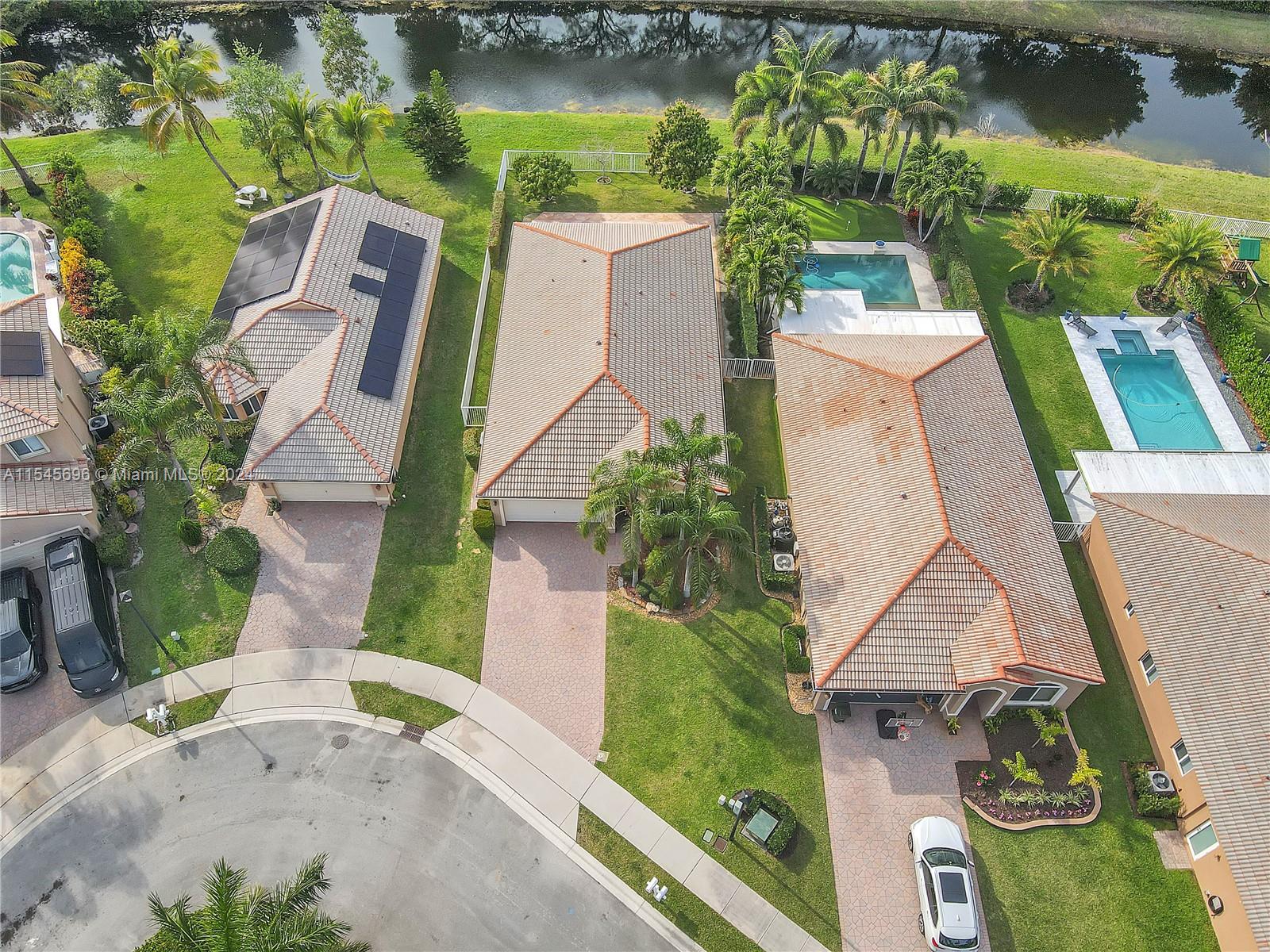 an aerial view of a house with outdoor space and a lake view