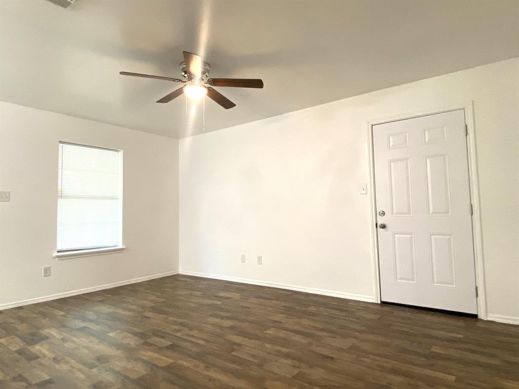 505 Red Springs Avenue Mount Pleasant, TX 75455 - Photo 6 of 9 Spare room with ceiling fan and dark wood-type flooring