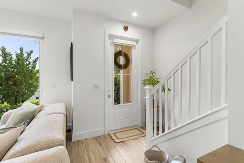 a kitchen with a sink a counter space appliances and wooden floor
