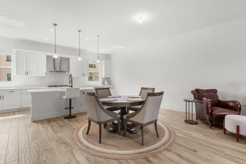 a kitchen with stainless steel appliances granite countertop a sink refrigerator and cabinets